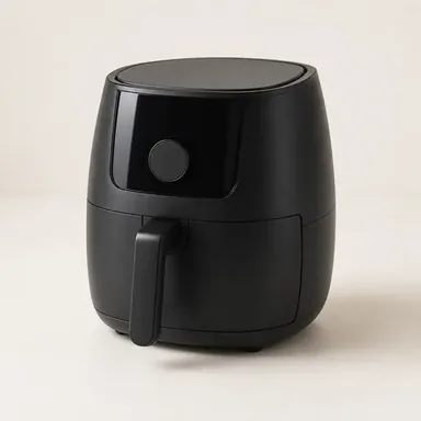 Black air fryer with the basket pulled out showing crisp food inside