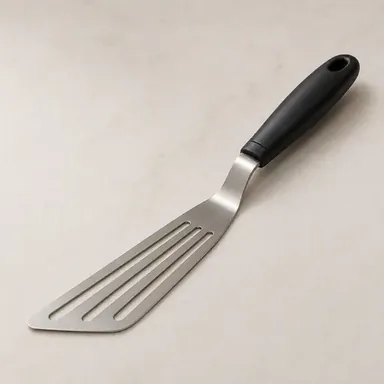 Thin flexible slotted fish spatula with a black handle
