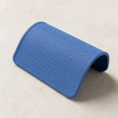 Blue silicone jar opener gripping the metal lid of a glass jar
