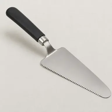 Serrated cake and pie server lifting a slice of fruit pie