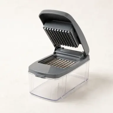 Vegetable chopper with a clear container holding freshly diced red onion